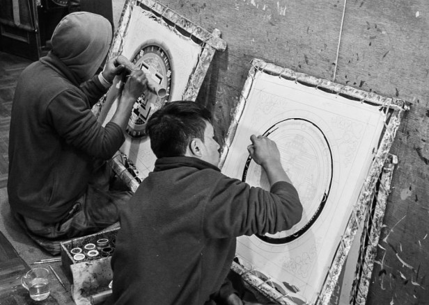 men painting mandalas